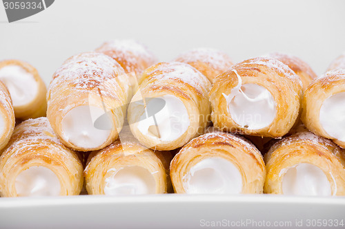 Image of tube of pastry filled with snow