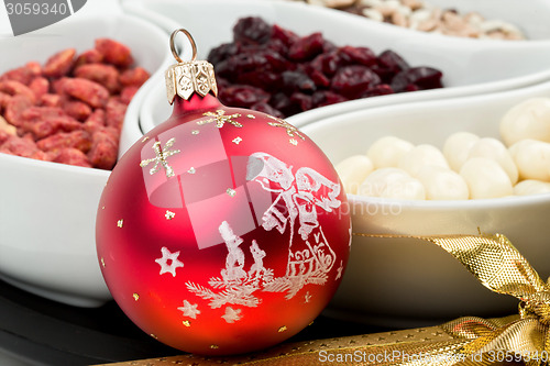 Image of Red christmas bal with chocolate nuts