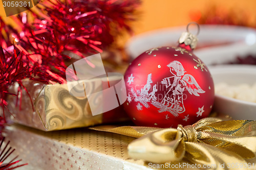 Image of christmas decoration and golden box with ribbon