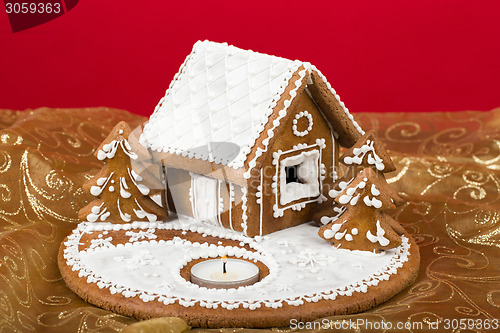 Image of Holiday Gingerbread house on red.