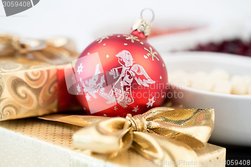 Image of christmas decoration and golden box with ribbon
