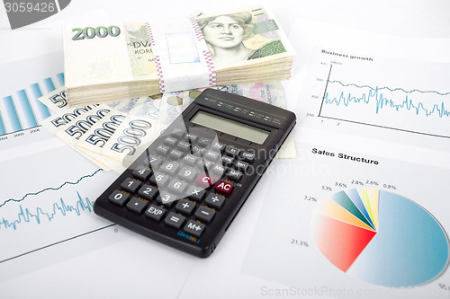 Image of calculator, charts, pen, business workplace