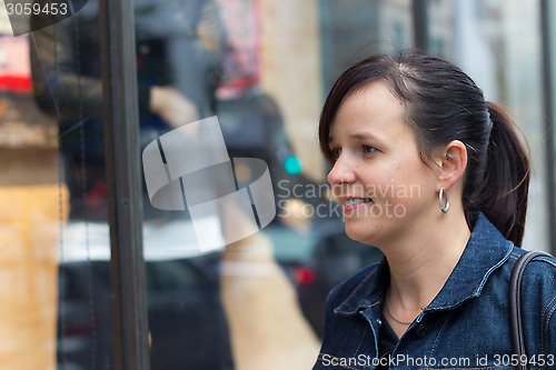 Image of Young woman window shopping