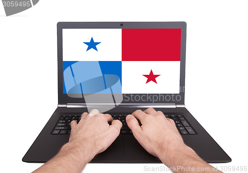 Image of Hands working on laptop, Panama