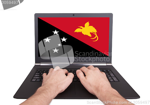 Image of Hands working on laptop, Papua New Guinea