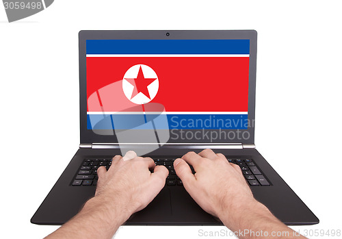 Image of Hands working on laptop, North Korea