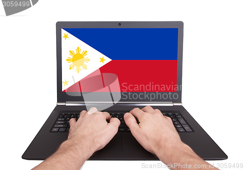 Image of Hands working on laptop, Philippines