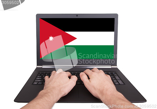 Image of Hands working on laptop, Jordan