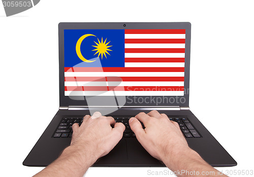 Image of Hands working on laptop, Malaysia