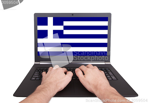 Image of Hands working on laptop, Greece