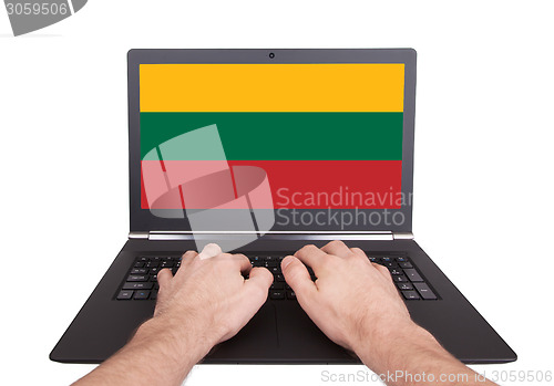 Image of Hands working on laptop, Lithuania