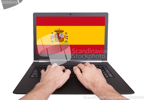 Image of Hands working on laptop, Spain