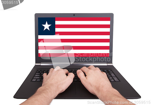 Image of Hands working on laptop, Liberia