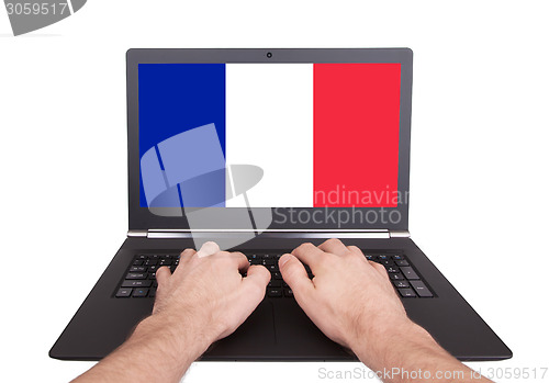 Image of Hands working on laptop, France