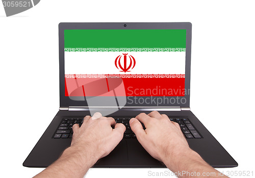 Image of Hands working on laptop, Iran