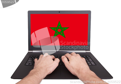 Image of Hands working on laptop, Morocco