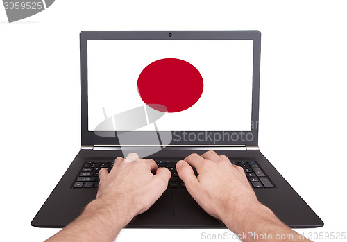 Image of Hands working on laptop, Japan