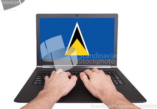 Image of Hands working on laptop, Saint Lucia