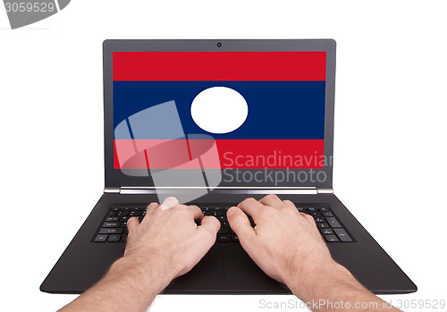 Image of Hands working on laptop, Laos