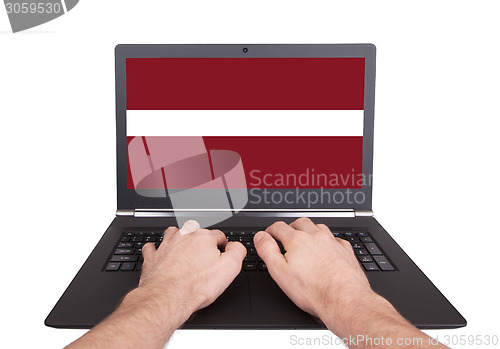 Image of Hands working on laptop, Latvia