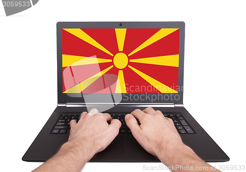 Image of Hands working on laptop, Macedonia