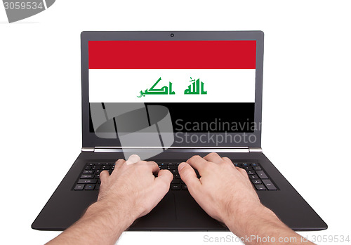 Image of Hands working on laptop, Iraq