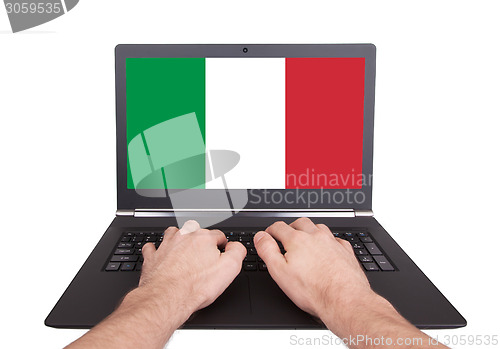Image of Hands working on laptop, Italy