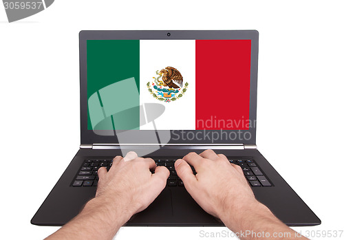 Image of Hands working on laptop, Mexico