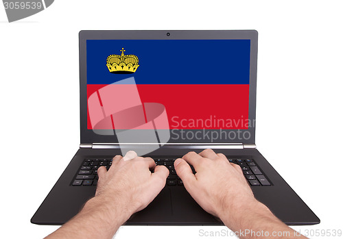 Image of Hands working on laptop, Liechtenstein