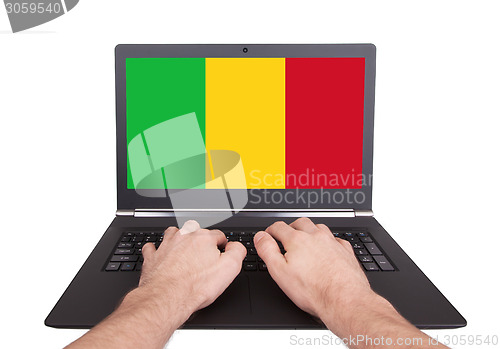 Image of Hands working on laptop, Mali