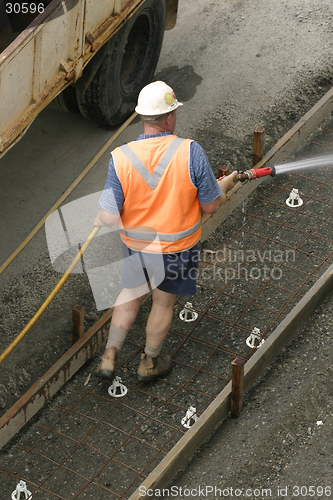 Image of Construction Worker Useing a Hose