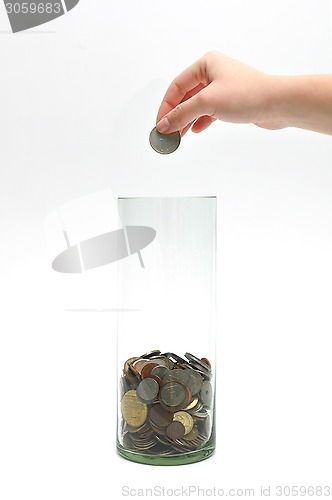 Image of dropping coin into glass jar