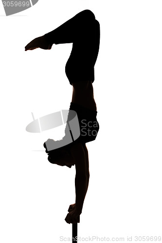Image of caucasian woman contortionist practicing gymnastic yoga in silhouette