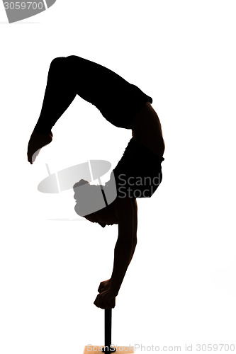 Image of caucasian woman contortionist practicing gymnastic yoga in silhouette