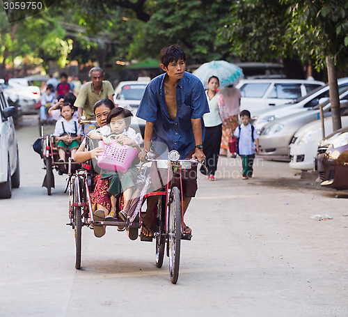 Image of Schoolchildren on cyclos in Yangon