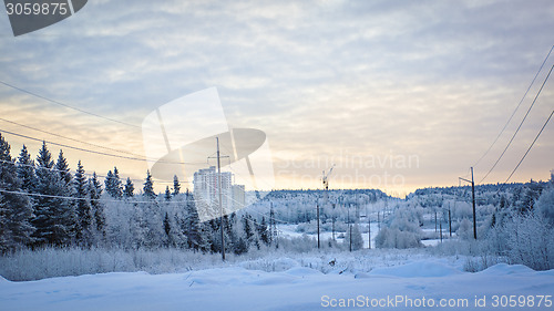 Image of Snowy road, forest and construction site on winter landscape