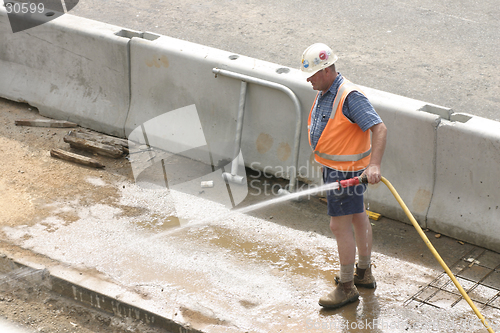 Image of Workman hosing, no sign