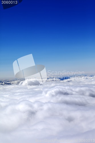 Image of Mountains under clouds and clear blue sky