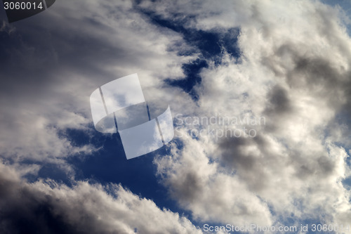 Image of Sky with sunlight and dark clouds before storm