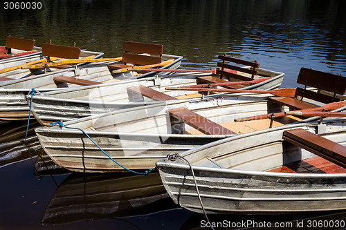 Image of Empty rowboats at a lake in a row