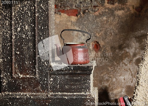Image of  old teapot in an abandoned house