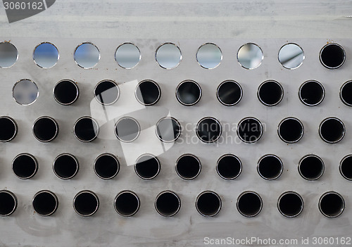 Image of Metal plate with holes and pipes