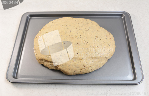 Image of Risen bread dough on a baking tray