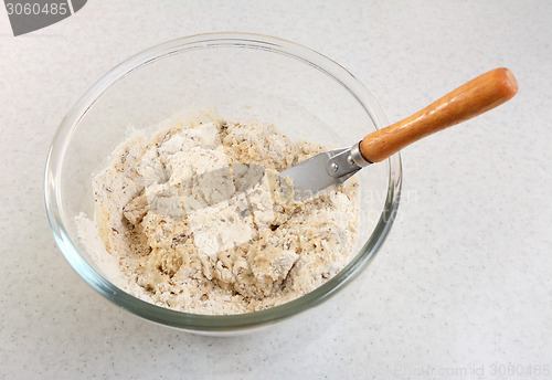 Image of Mixing malted bread mix with a palette knife 