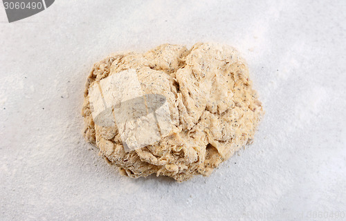 Image of Rough ball of bread dough on a floured work surface