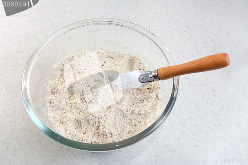 Image of Mixing bread flour mix and butter with a knife