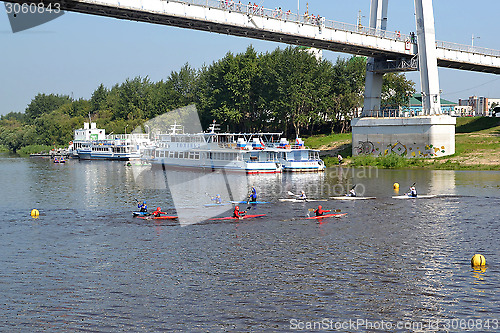 Image of People on kayaks and Tyumen-2 motor ships under the foot bridge 