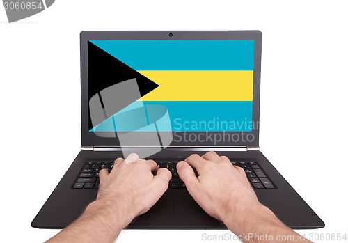 Image of Hands working on laptop, Bahamas