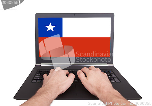 Image of Hands working on laptop, Chile