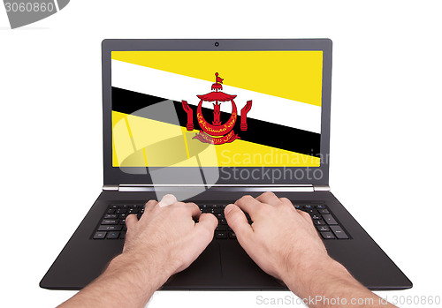 Image of Hands working on laptop, Brunei